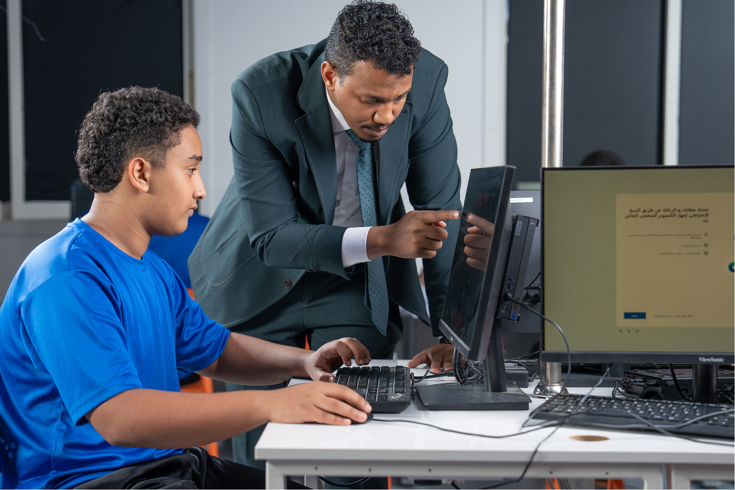 Teacher helping a student with e-safety