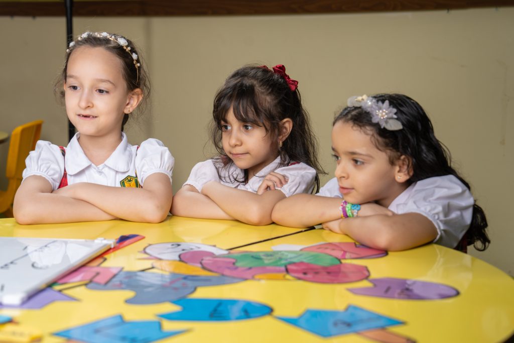 Young students learning in a classroom at a school in Ajman